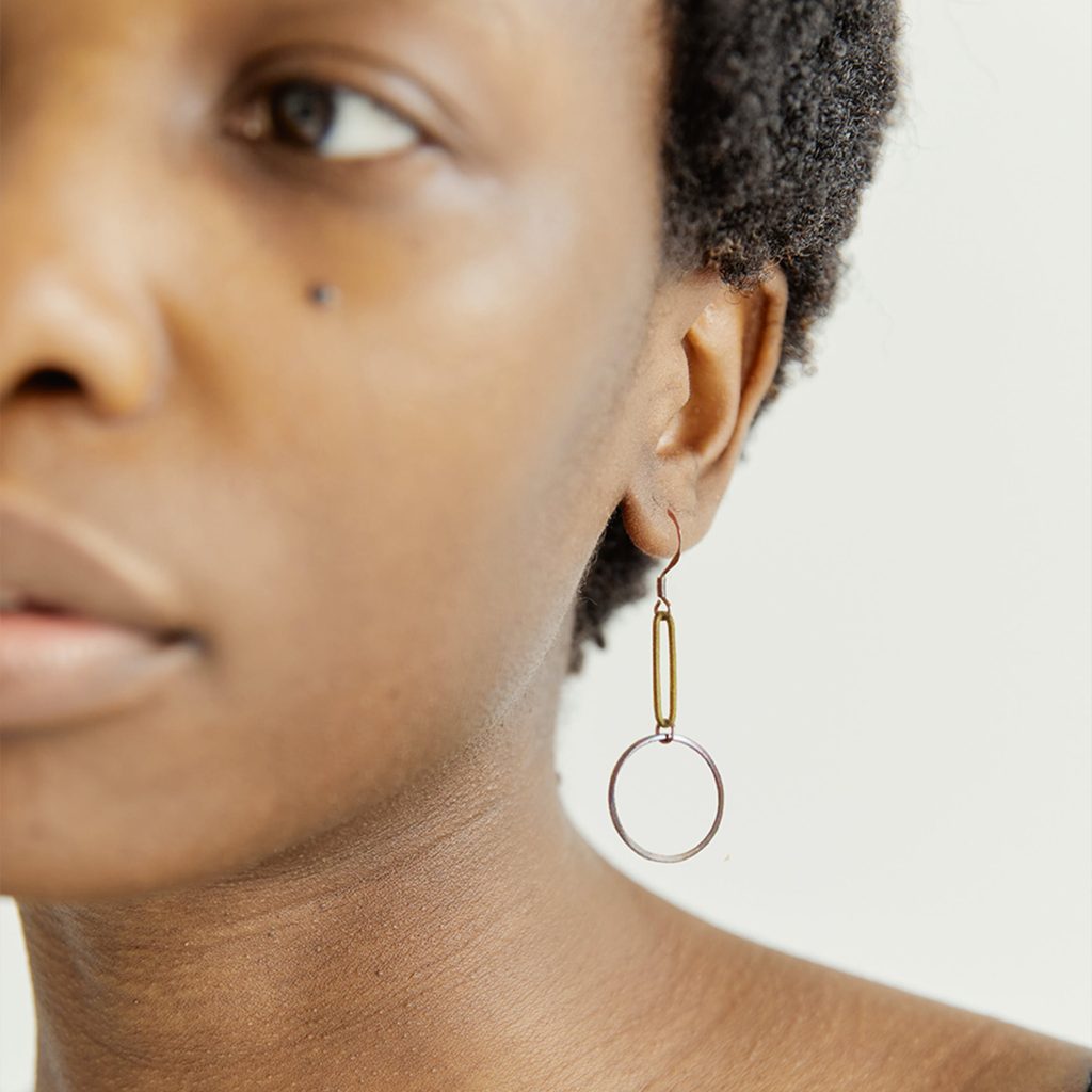 Female model showcasing earring jewellery design by ACID member Factory Floor Jewels