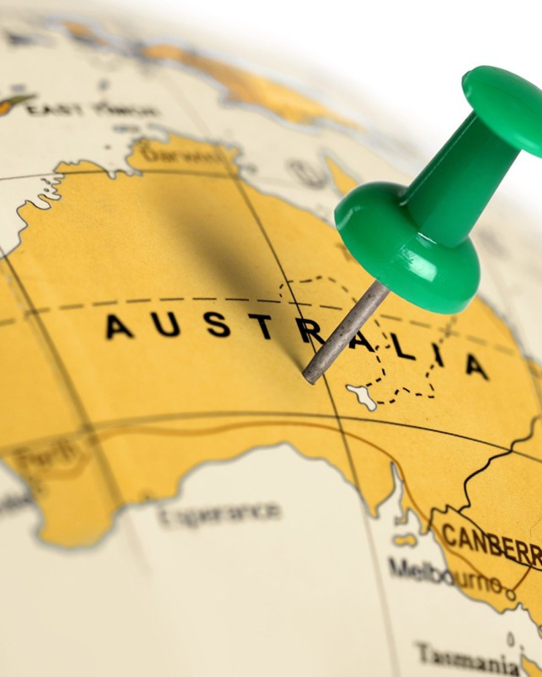 Globe with a green pin marking Australia